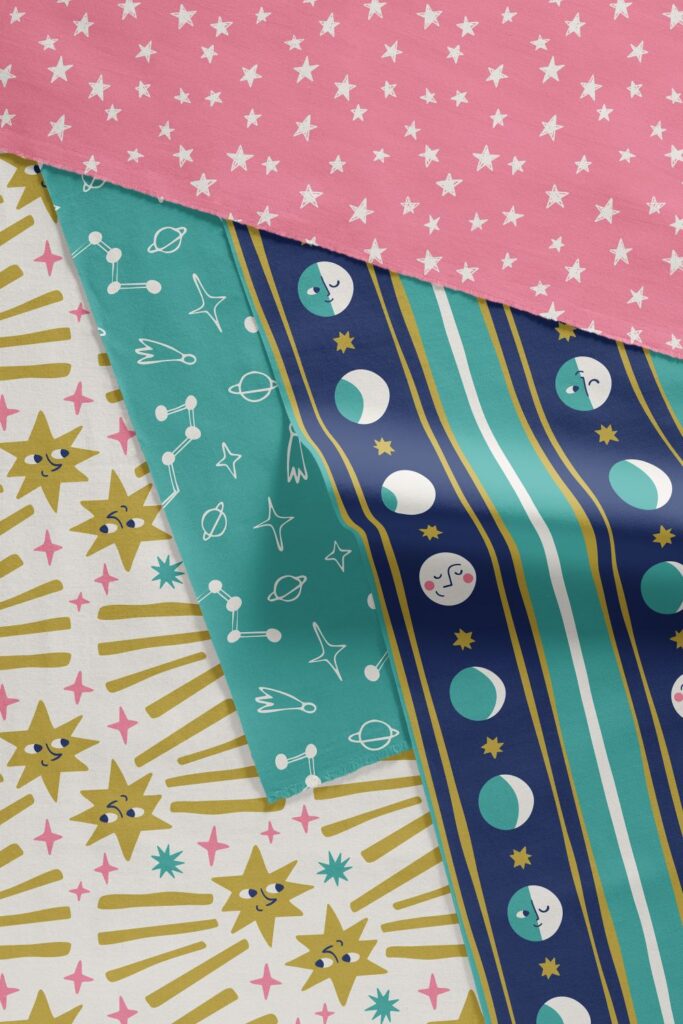 fun celestial fabric by the yard ideal for kids clothing, in teal yellow and pink palette